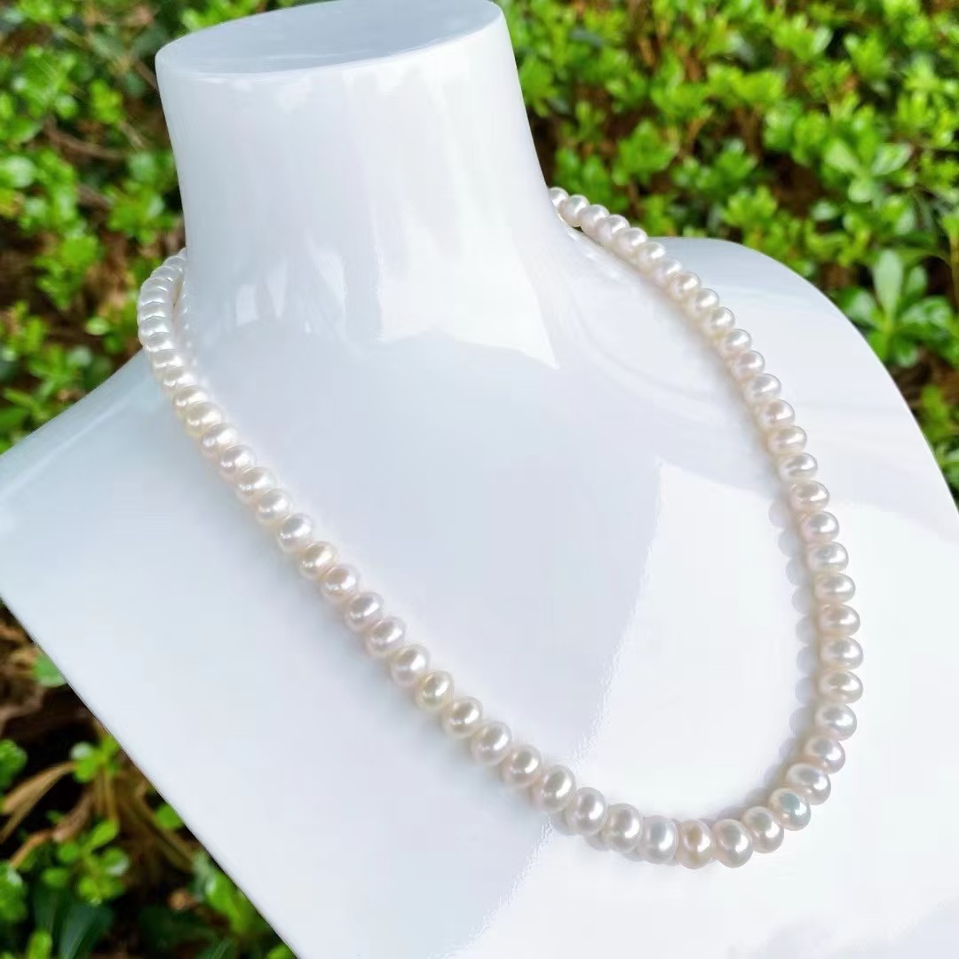 Premium retail product display featuring elegant jewelry and accessories arranged on a marble surface with soft lighting and luxury packaging