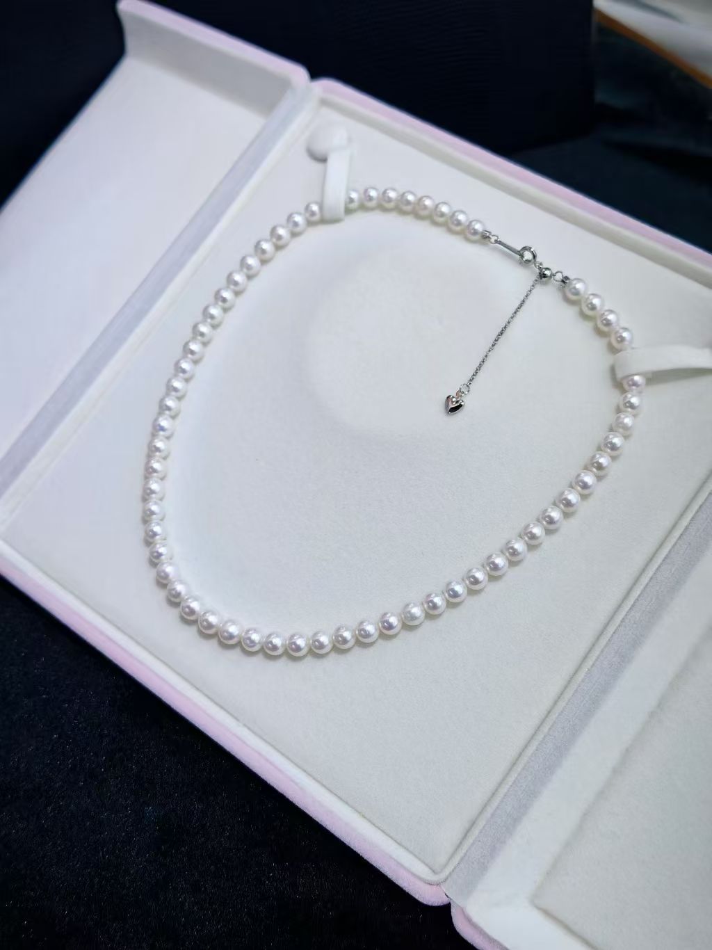 Elegant pearl necklace with gold clasp displayed against a soft background with natural lighting